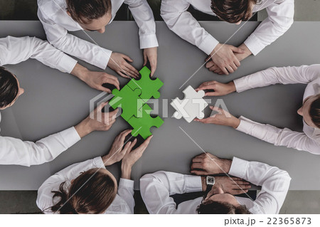 Business people assembling puzzle 22365873