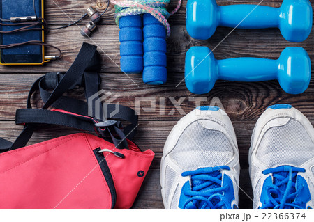 Shoes and sports equipment on wooden floor, top Shoes and sports equipment on wooden floor, top 22366374