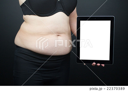 メタボ 腹 タブレット 合成素材の写真素材