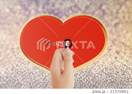 Isolated hand with lens and text honest with red heart shape on Isolated hand with lens and text honest with red heart shape on 22370861