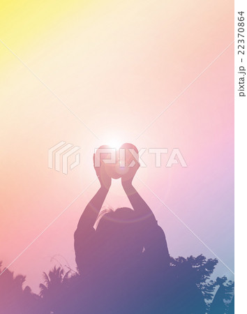 Silhouette back of women raise haert to sky in twilight Silhouette back of women raise haert to sky in twilight 22370864