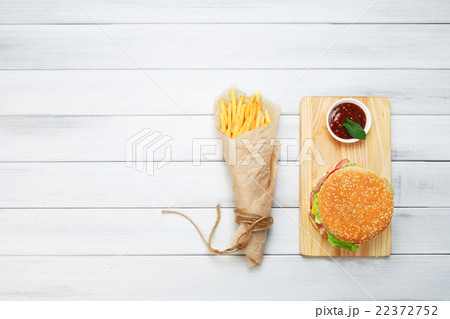 Burger, chips and ketchup at white wood 22372752