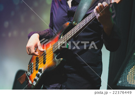 Rock and roll music, bass guitar player closeup 22376449