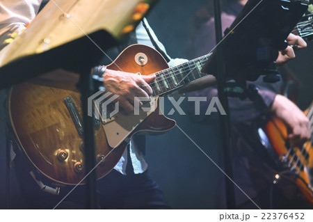 Old style rock music background, guitar player Old style rock music background, guitar player 22376452