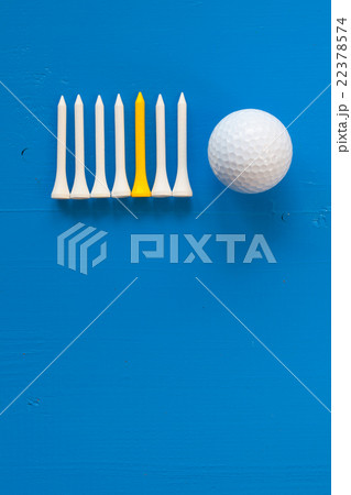 Golf ball and wooden golf tees on the blue desk Golf ball and wooden golf tees on the blue desk 22378574