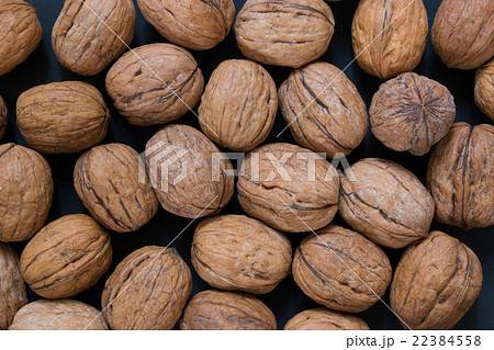 Walnut background, scattered pile of walnuts Walnut background, scattered pile of walnuts 22384558