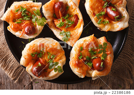 Tasty muffins with sausage and cheese close-up 22386186