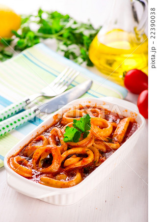 Stewed squid rings with tomato sauce, white plate Stewed squid rings with tomato sauce, white plate 22390038