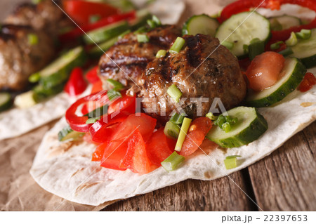 Meatballs with fresh vegetables on a tortilla 22397653