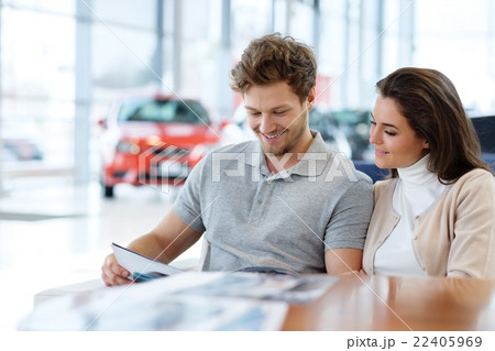 Young couple at the dealership showroom. 22405969
