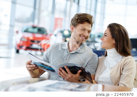Young couple at the dealership showroom. 22405970