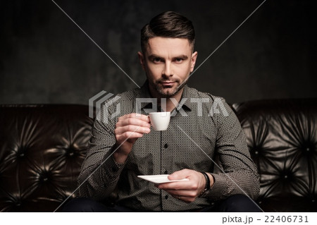 Well-groomed man posing on dark background. Well-groomed man posing on dark background. 22406731