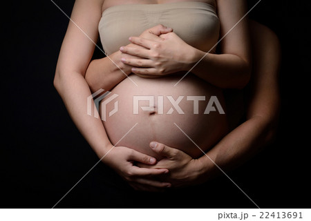 hands of pregnant woman and her husband on belly hands of pregnant woman and her husband on belly 22413691