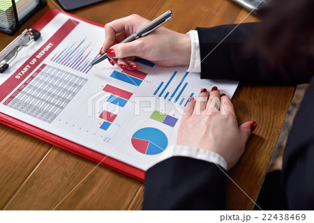 businesswoman checks report businesswoman checks report 22438469