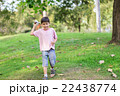 Little sibling boy playing plane paper in the park 22438774