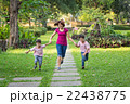 mother running in the park with sons 22438775