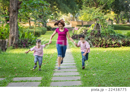 mother running in the park with sons mother running in the park with sons 22438775