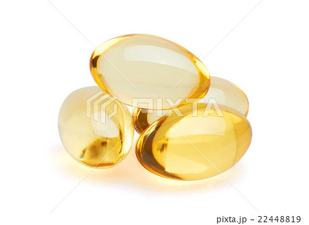 Yellow pills on white 22448819