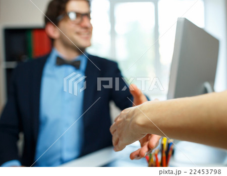 Modern business man with arm extended to handshake 22453798