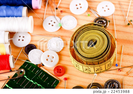 Tape measure with accessories on wooden board 22453988