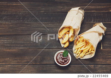 Fries and potato wedges wrapped takeaway at wood 22455469