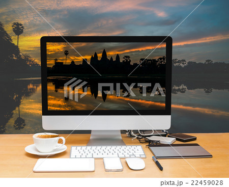 Conceptual image of a workspace with computer desktop on Silhouette of Angkor Wat sunrise at Siem Reap. Cambodia Conceptual image of a workspace with computer desktop on Silhouette of Angkor Wat sunrise at Siem Reap. Cambodia 22459028