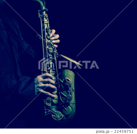 Closeup saxophone in player action on a dark background 22459751
