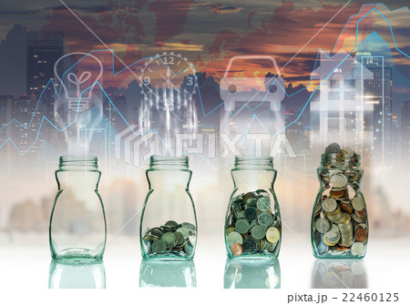 Mix coins in clear bottle on trading graph with cityscape background with sign shape,Business investment growth concept 22460125