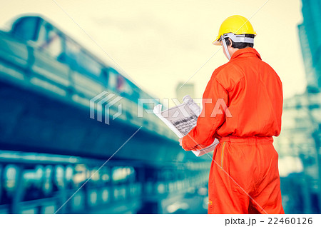 Portrait of Asian engineers looking at the blueprint on abstract Blurred photo of sky train, transportation industrial concept 22460126
