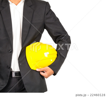 engineer in suit holding yellow helmet for workers security on white background, include clipping path, industrial concept engineer in suit holding yellow helmet for workers security on white background, include clipping path, industrial concept 22460128