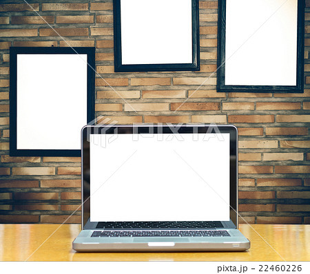 Computer notebook on brick wall background with advertise frame Computer notebook on brick wall background with advertise frame 22460226