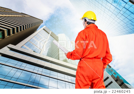 Portrait of Asian engineers holding at the blueprint on Modern business building glass of skyscrapers, Business concept of architecture industrial concept 22460245
