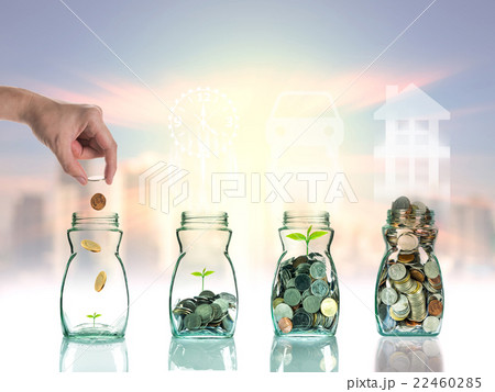 Hand putting mix coins and seed in clear bottle on cityscape photo blurred cityscape background with sign shape,Business investment growth concept Hand putting mix coins and seed in clear bottle on cityscape photo blurred cityscape background with sign shape,Business investment growth concept 22460285