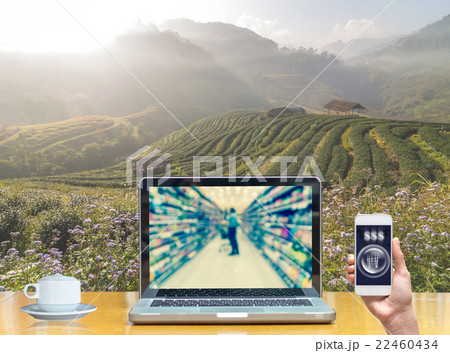 Computer notebook with holding smart mobile on Tea field when sunrise with fog, show Abstract blurred photo of store with trolley in department store bokeh background, online shopping concept Computer notebook with holding smart mobile on Tea field when sunrise with fog, show Abstract blurred photo of store with trolley in department store bokeh background, online shopping concept 22460434