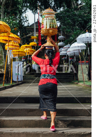 Woman carrying ceremonial offerings on her head 22462661