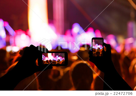 Take photo crowd in front of concert stage blurred 22472706
