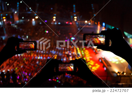 Take photo crowd in front of concert stage blurred 22472707