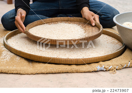 woman competitive winnowing rice by using bamboo b woman competitive winnowing rice by using bamboo b 22473907