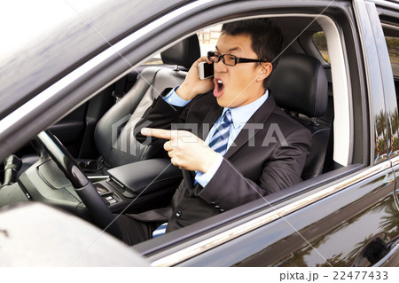 businessman talking with cell phone in the car businessman talking with cell phone in the car 22477433