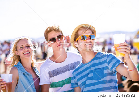 Group of teenagers at summer music festival, sunny Group of teenagers at summer music festival, sunny 22483532