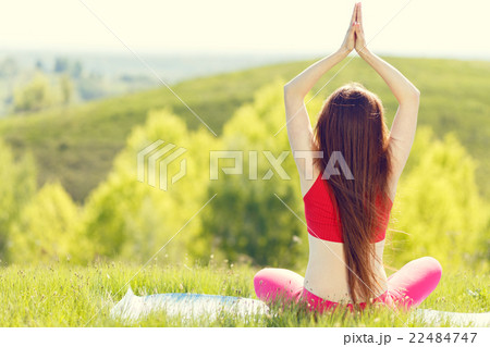 Young woman doing yoga pose outdoor in the morning Young woman doing yoga pose outdoor in the morning 22484747