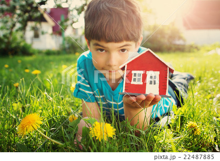 child holding red model house 22487885