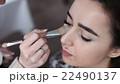 A cute model gets makeup put on before her shoot 22490137