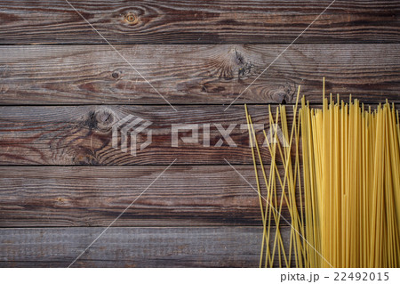 Yellow long spaghetti on black background. Raw Yellow long spaghetti on black background. Raw 22492015