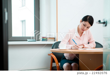 Woman Writing in paper.  22492076
