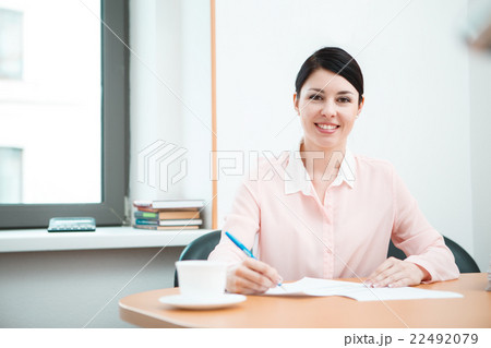 wonam work with papers in office room. 22492079