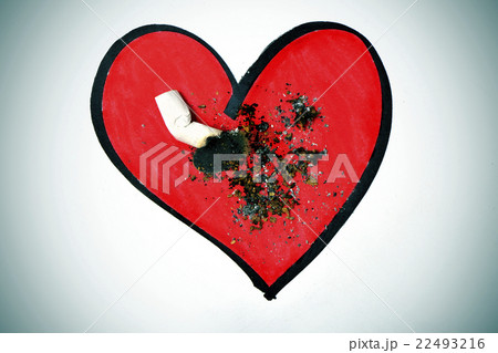 cigarette butt on a drawing of a heart cigarette butt on a drawing of a heart 22493216