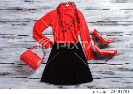 Red top with black skirt. Red top with black skirt. 22493793