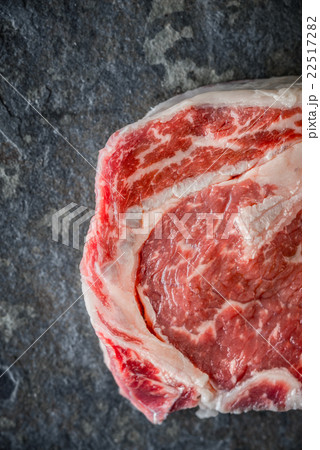 Piece of Ribeye steak on a marble gray-blue slate 22517282