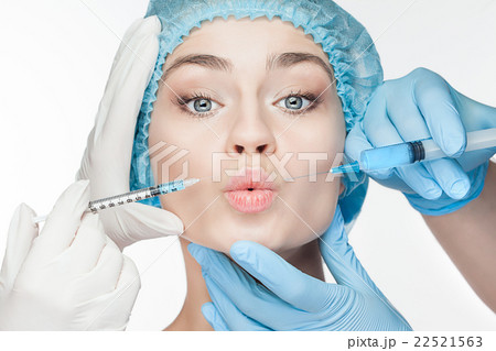 Attractive woman at plastic surgery with syringe 22521563